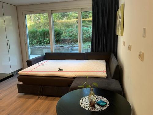 a bed in a room with a table and a window at Holmenkollen Forest House free parking in Oslo
