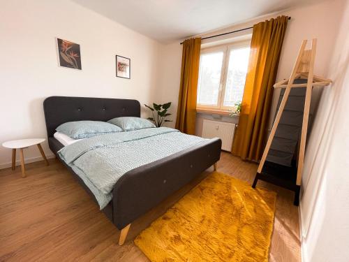 a bedroom with a bed and a ladder and a window at Modern Oasis in the Heart of the City in Košice