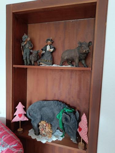 a wooden shelf with figurines of animals on it at Wellness und Romantik Hotel Helmboldt in Bad Sachsa