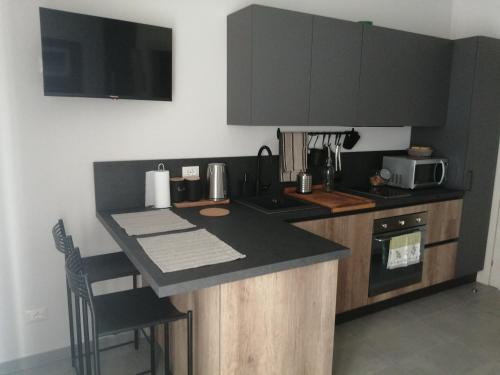 a kitchen with a counter top and a stove top oven at Stanze Ildesco in Bergamo