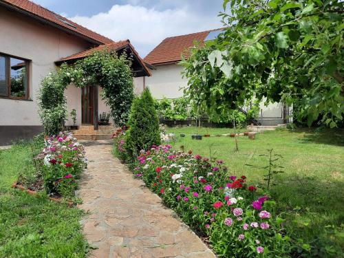 a garden of flowers in front of a house at Camping place in Alba Iulia