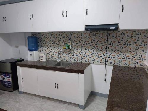 a kitchen with a sink and a counter top at FOMAG House GenSan 2BR in General Santos
