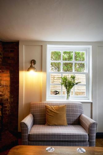 a couch in a living room with a window at The Royal in Wallingford