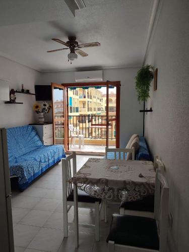 a living room with a table and a bed at Daria in La Mata