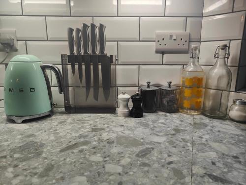 a kitchen counter with utensils on a counter top at Self-contained flat, off street parking close to town and beach in Bournemouth
