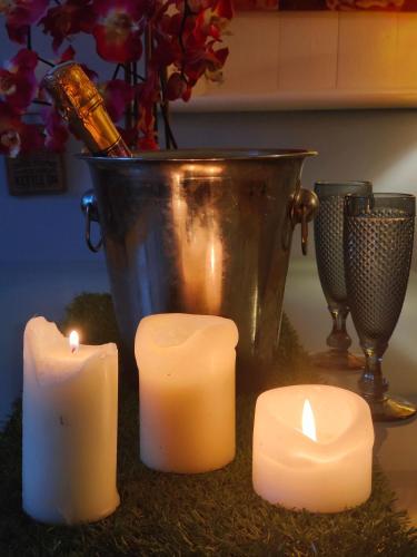 a group of candles on a table with a bucket at Self-contained flat, off street parking close to town and beach in Bournemouth