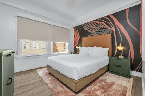 a bedroom with a bed and a large window at Nob Hill Hotel in San Francisco
