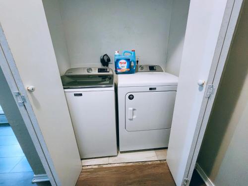 a small laundry room with a washer and dryer at Kathmandu Cowboy- At&T Stadium in Arlington