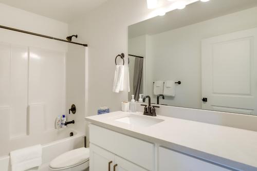 a bathroom with a sink and a toilet and a mirror at Inviting American Fork Home with Community Pool! in American Fork