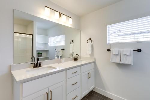 a white bathroom with two sinks and a mirror at Inviting American Fork Home with Community Pool! in American Fork