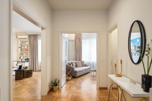 a living room with a couch and a mirror at Anaktora Luxury Apartment at Kolonaki in Athens