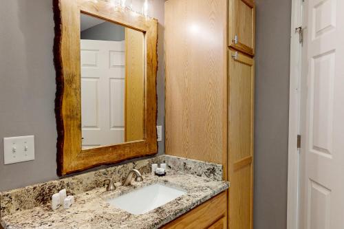 a bathroom with a sink and a mirror at Sky Reach at Beech in Beech Mountain