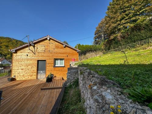 a wooden deck in front of a house at Le Tipani in Vernon