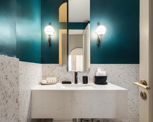 a bathroom with a sink and a mirror at Anaktora Luxury Apartment at Kolonaki in Athens