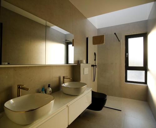 a bathroom with two sinks and a toilet in it at Neptunia - 4 bedroom villa in Medulin