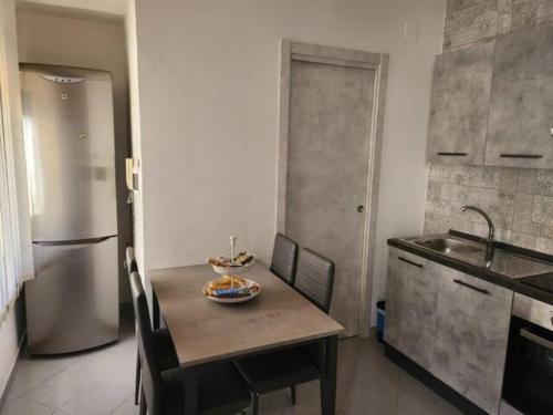 a kitchen with a table with a bowl of fruit on it at Notti al Vesuvio in Boscoreale