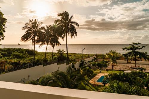 a view of the beach from the balcony of a resort at Stella Marris beachfront villa in Pointe aux Sable
