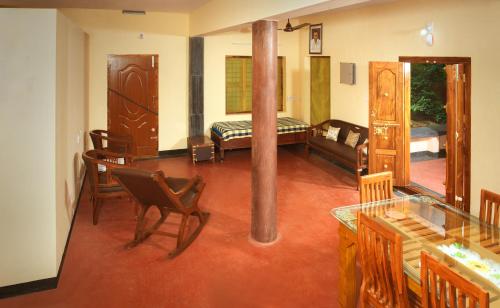 a room with a living room with a smoking pipe at Villa in the woods in Trichūr