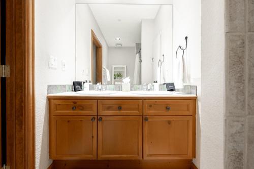 a bathroom with a sink and a large mirror at Mountain Views Galore - Avon Condo - Walk to Town in Avon