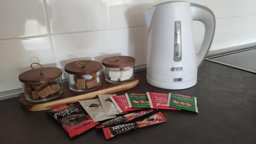 a kitchen counter with a coffee maker and some food at No1Apartments in Požarevac