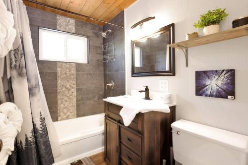 a bathroom with a sink and a tub and a toilet at Ursa Major- Ultra Modern Resort Duplex- in Big Bear Lake