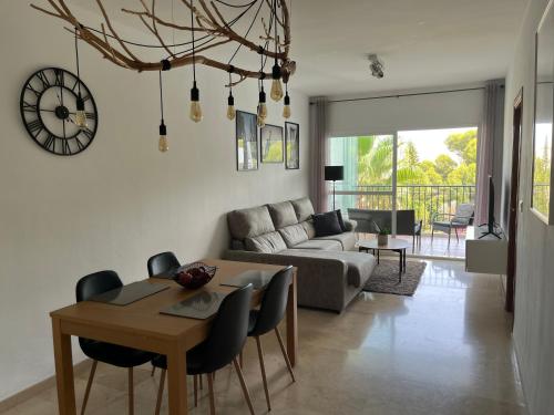 uma sala de estar com uma mesa e um sofá em Apartment Summer Vibes Miraflores - La Cala de Mijas em La Cala de Mijas