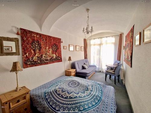 a bedroom with a bed and a couch and a chair at Elbenland Apartments Sächsische Schweiz in Sebnitz