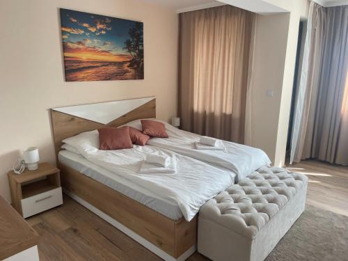 a bedroom with a large bed with white sheets at Teddy Apartment in Veliko Tŭrnovo