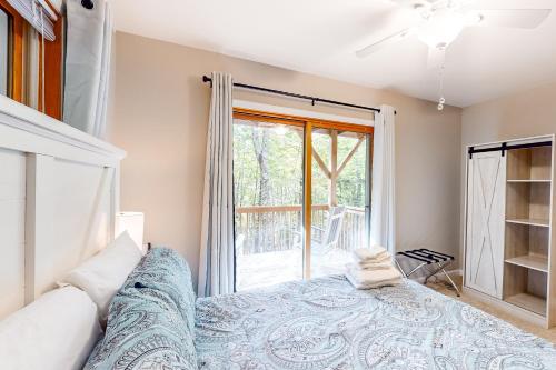 a bedroom with a bed and a window at Sandy Beech in Beech Mountain