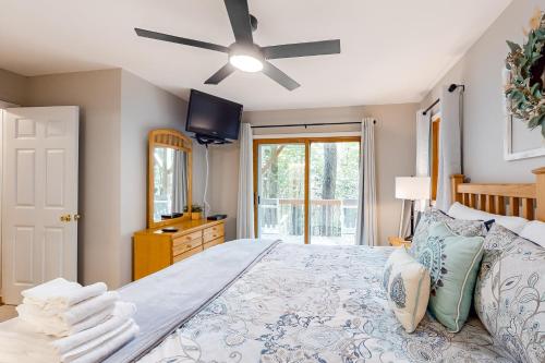 a bedroom with a large bed with a ceiling fan at Sandy Beech in Beech Mountain