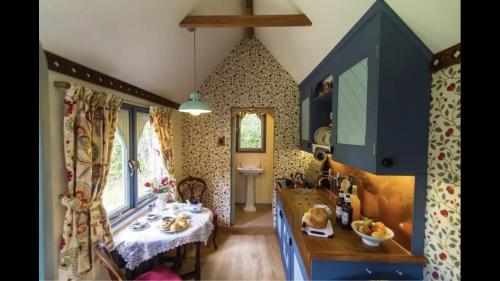 a room with a table and a dining room at Magical Tabernacle in a Beautiful Setting with Hot Tub in Bude