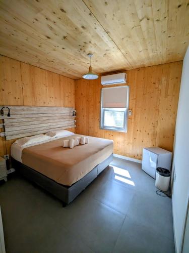 a bedroom with a large bed in a wooden room at Wanderlust José Ignacio in José Ignacio