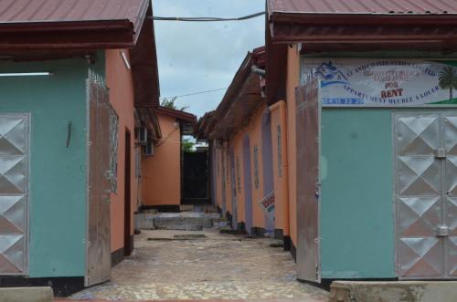 an alley with blue and orange buildings at EDISON CITY PALACE GUEST HOME in Bertoua