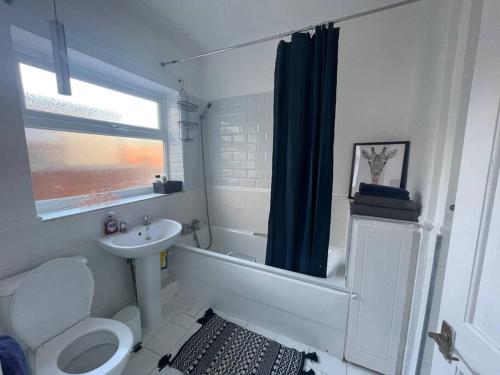 a bathroom with a sink and a toilet and a shower at 3 Bedroom House in Dartford in Kent