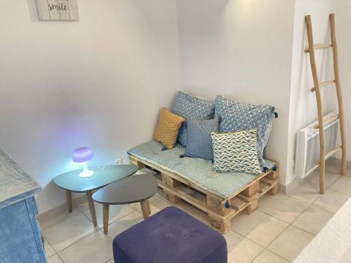 a living room with a couch and a table at Maison de vacances face à la mer in Saint Pierre La Mer