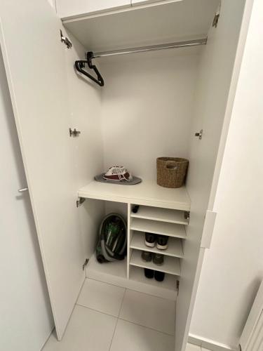 a walk in closet with white walls at Thyke Apartment in Krapinske Toplice