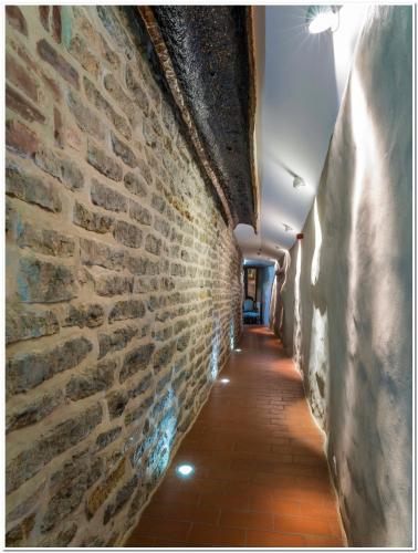 an alley way with a brick wall at CRU Hotel in Tallinn
