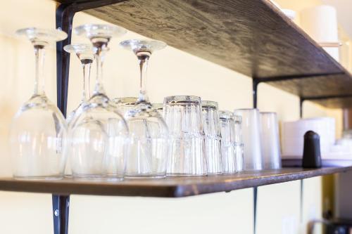 a shelf with wine glasses sitting on it at EXPERIENCE in Pescadero