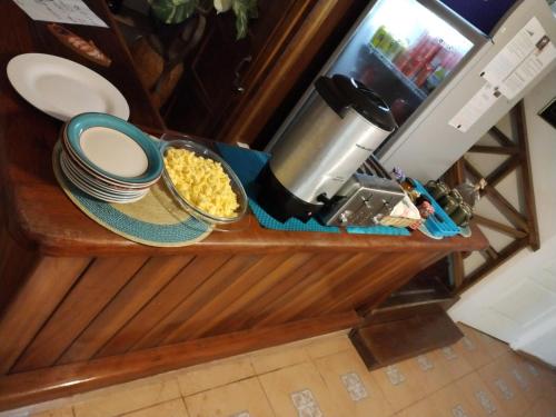 a counter with plates and bowls of food on it at Tierra Verde Bed & Breakfast in Bocas del Toro