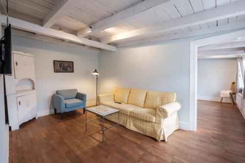 a living room with a couch and a chair at Zaunkönig Apartments in Baden-Baden