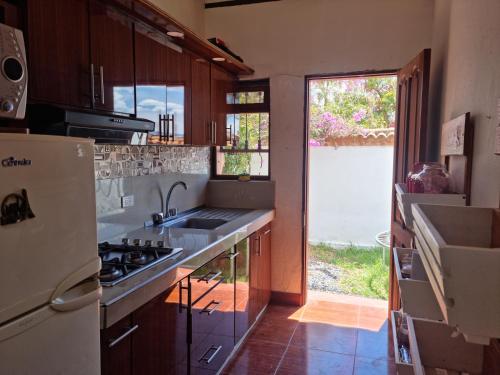 a kitchen with a sink and a stove top oven at La Casa De La Abuela in Villa de Leyva
