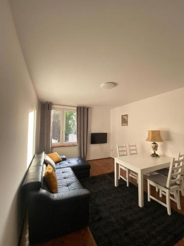 a living room with a couch and a table at Apartament Celna in Nysa