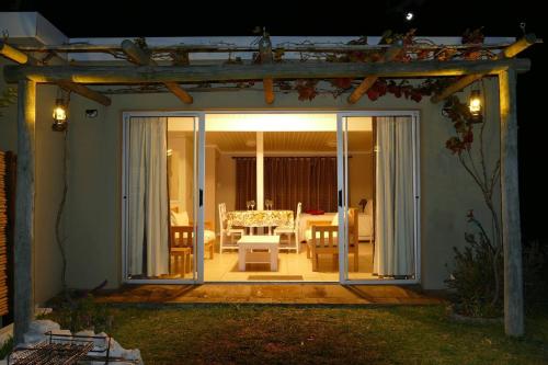 an open door to a patio with a table at Cuckoo's Corner in Bettyʼs Bay