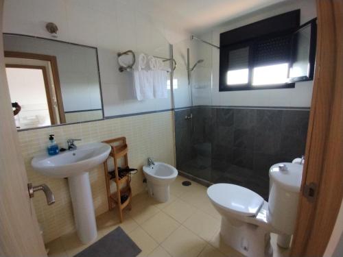 a bathroom with a sink and a toilet and a shower at Marine Melody House - Perfect for relaxing getaway in Lajares
