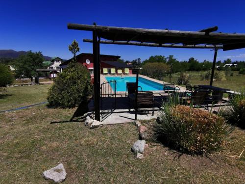 a swimming pool in a yard with a pavilion at cabañas altos de giardino in Villa Giardino