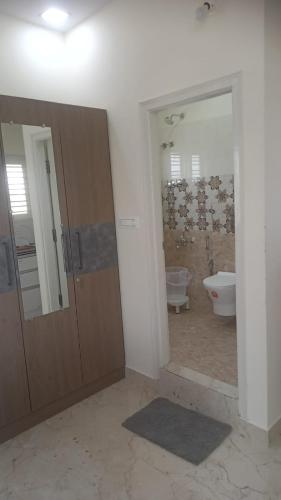 a bathroom with a tub and a toilet and a sink at DEEYA Guest House - A Luxury Home Stay in Mysore