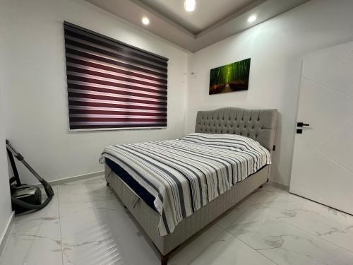 a bed in a white room with a window at Sare Life 1 in Alanya
