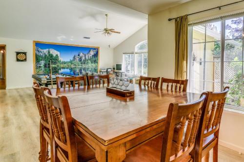 a dining room with a large wooden table and chairs at Pet Friendly Mariposa Retreat with Spacious Patio! in Mariposa