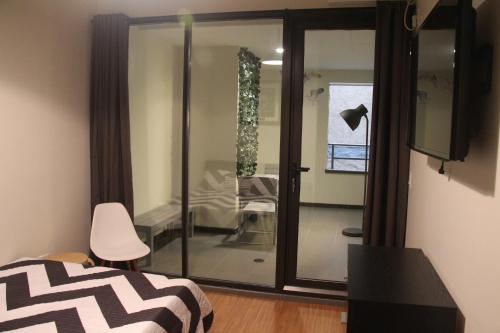 a bedroom with a glass door leading into a room at Jazz on Columbus Circle Hostel in New York
