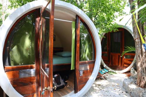 a round room with a bed inside of it at Hostal Mulut Tulum in Tulum